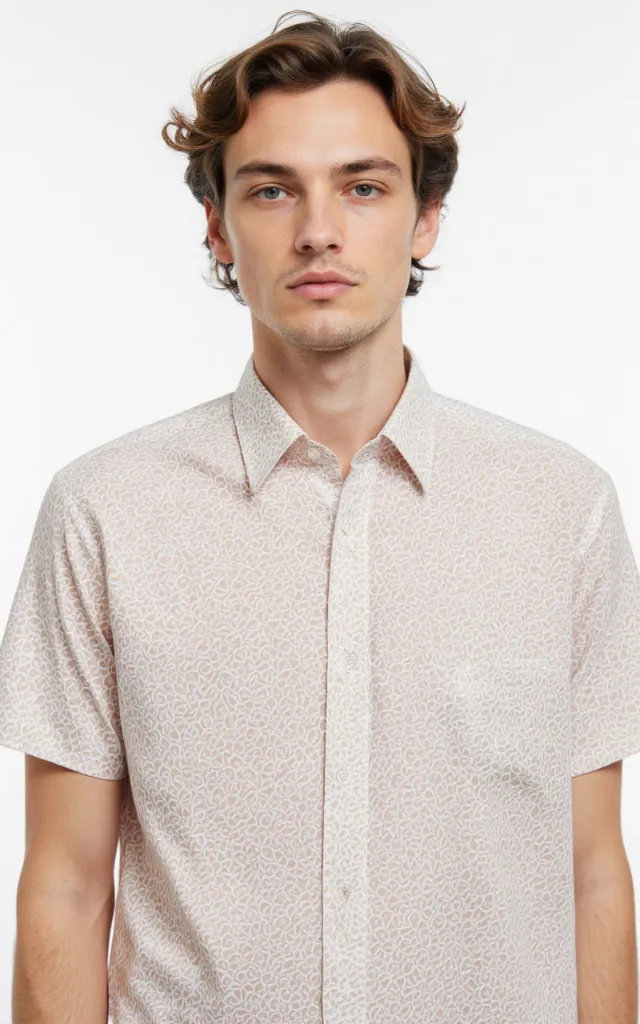 A French model wearing a Honeycomb pattern   printed shirt, against a white background, in a front   facing bust portrait